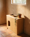 Natural oak litter cabinet used as an entryway console in warm light