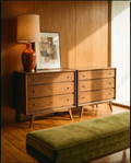 Pair of walnut three-drawer dressers against a teak panelled wall