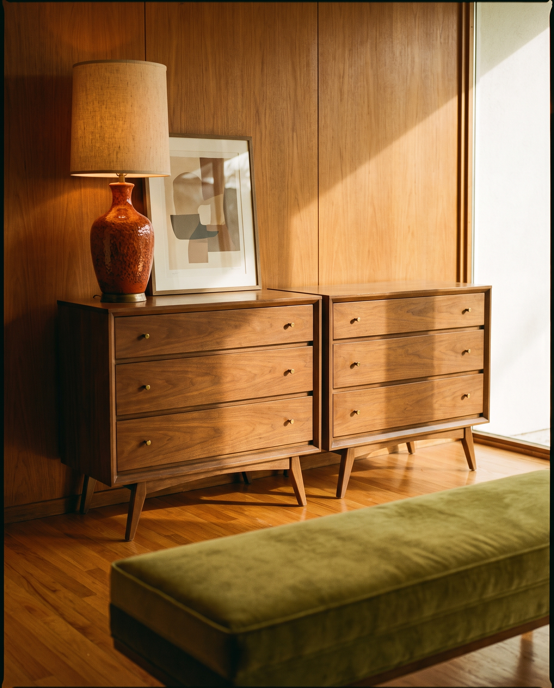 Pair of walnut three-drawer dressers against a teak panelled wall
