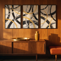 Black, white and gold circle triptych above a walnut console in an entryway
