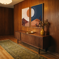 Two wood-framed sun and moon desert prints on an entryway wall
